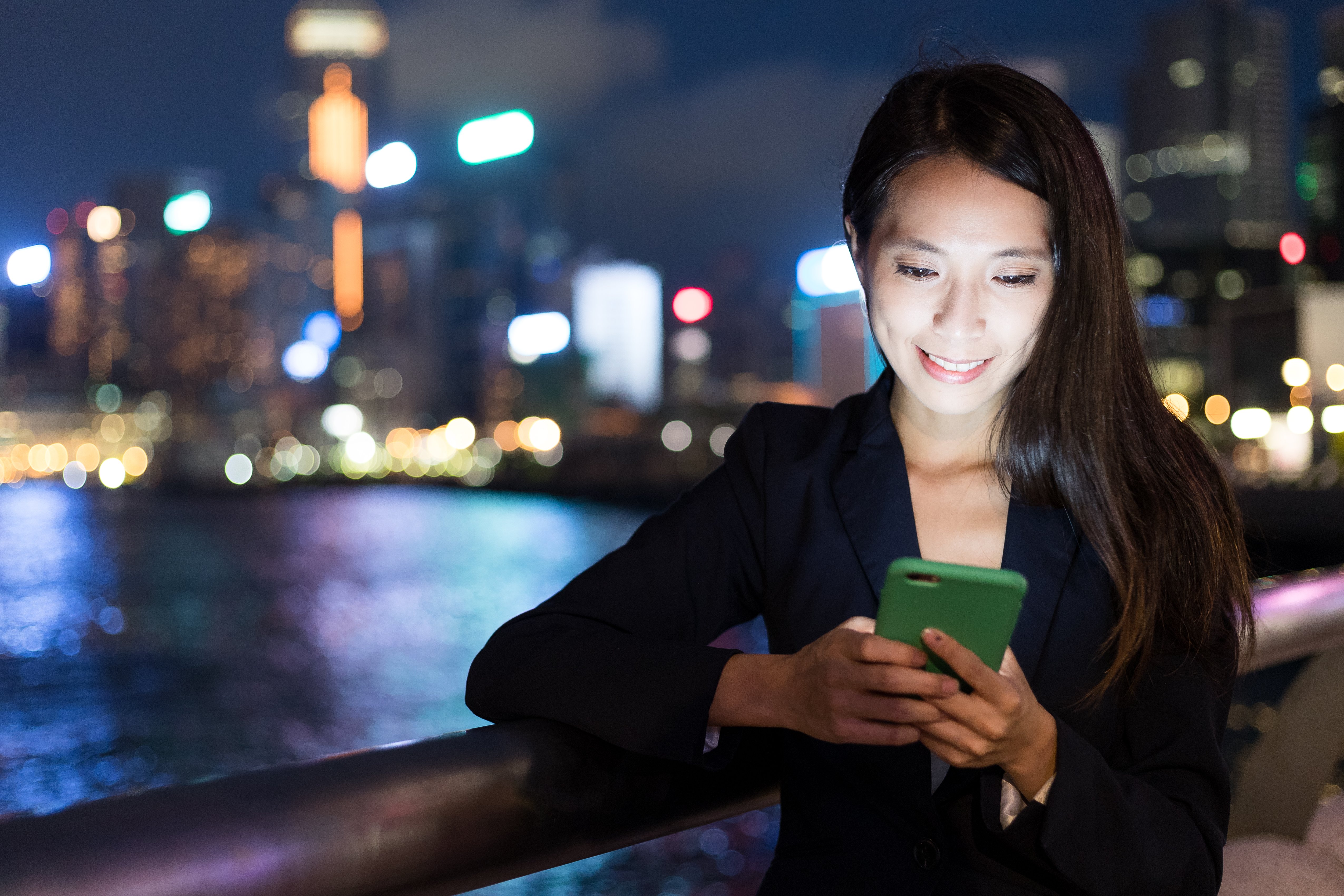 business-woman-using-cellphone-hong-kong-city