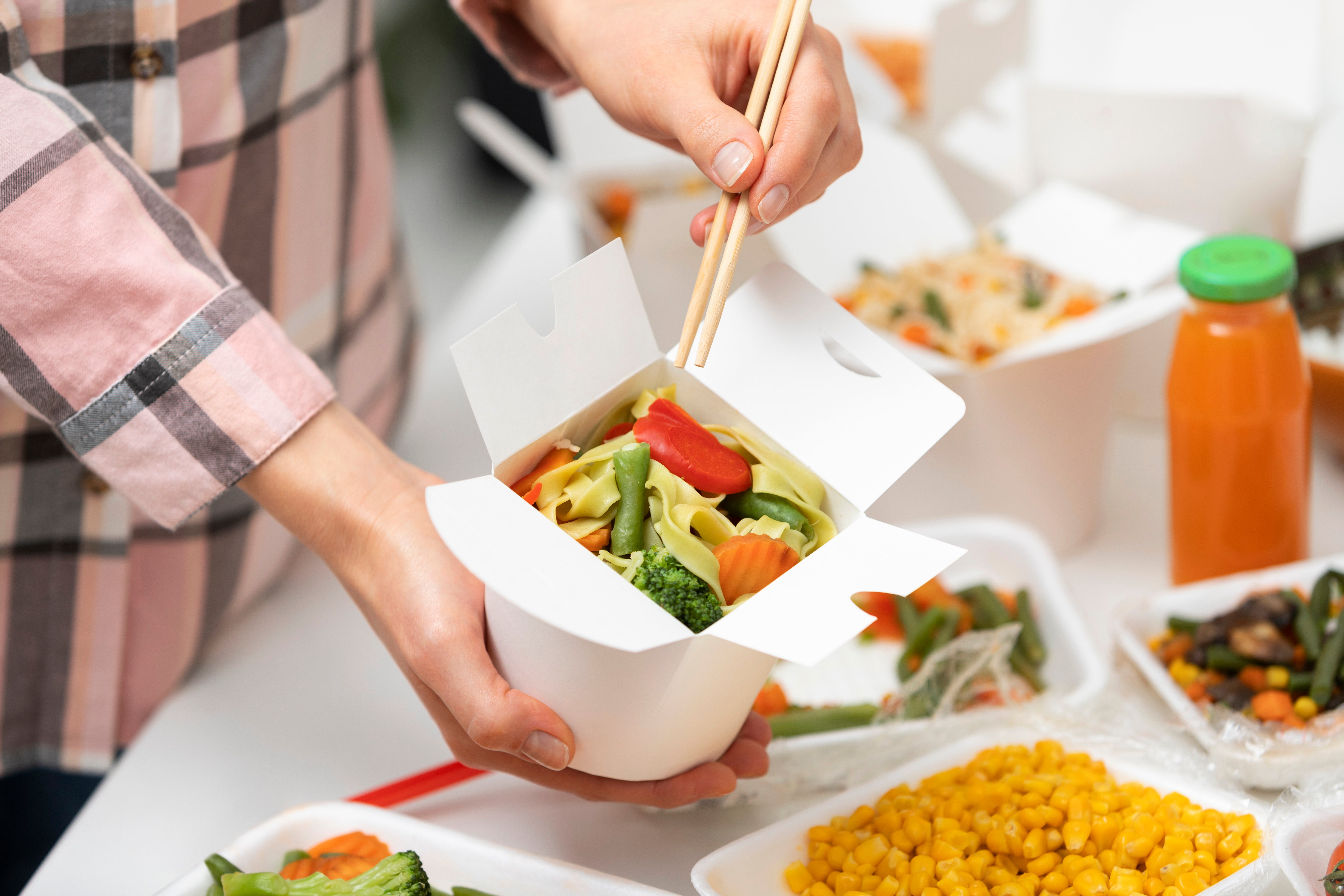 close-up-hand-holding-chopsticks