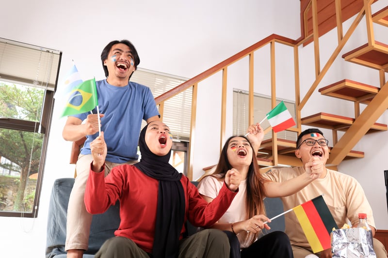 group-young-asian-friends-cheering-while-watching-sports-match-together