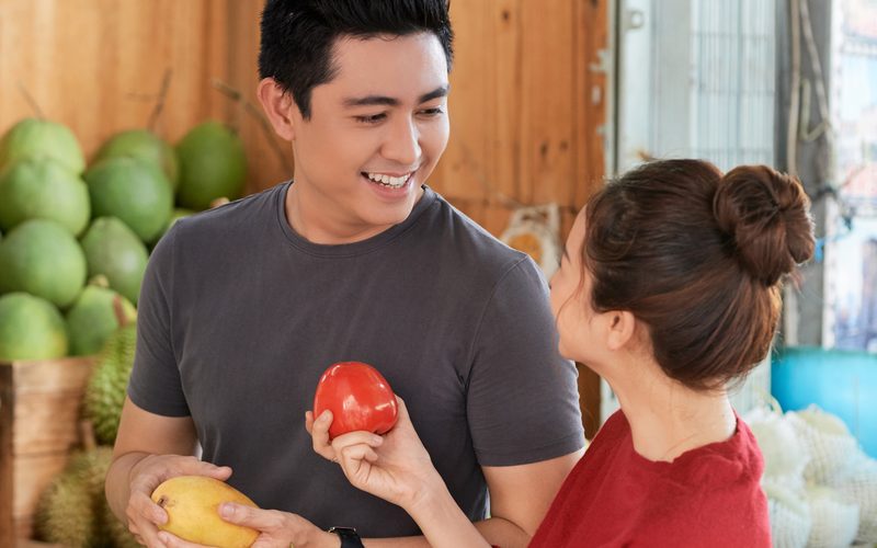 Couple choosing fruit together at a local market
