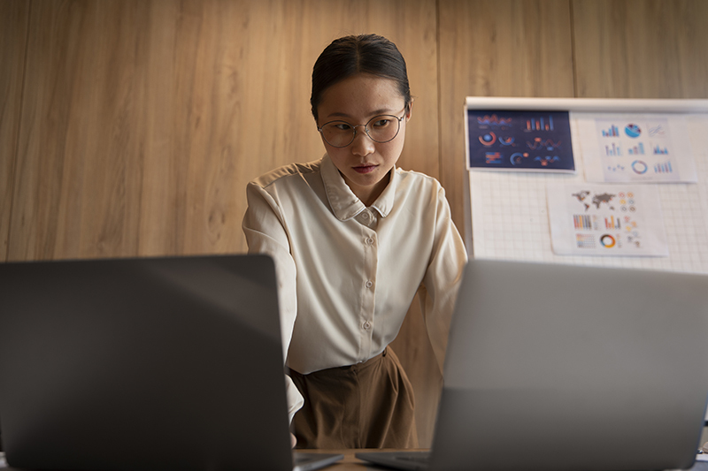 Office worker reviewing finance graphs and survey data